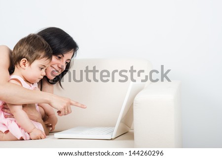Young Mom Shows Her Baby Something On The Laptop