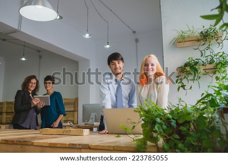 Four entrepreneurs smiling and looking direct to camera.