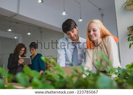 Couple working on laptop and other couple on tablet.