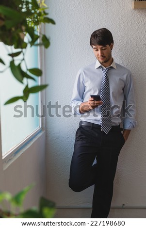 Young business man looking at phone