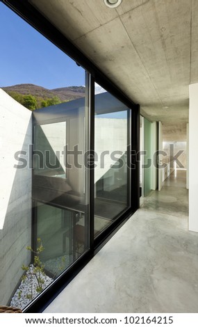 beautiful modern house in cement, interior, long corridor with windows