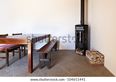 room with table and wood stove, rural home interior