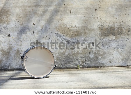 drum in front of a wall