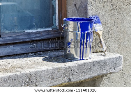 bucket and paint to paint the walls of the house