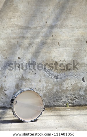 drum in front of a wall