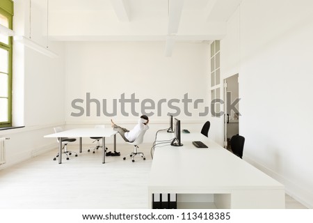 interior, office with modern furniture, man relaxes