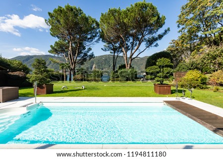 Exterior with swimming pool, garden and lake view. Nobody inside