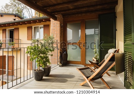 Balcony with deckchairs in a house. Nobody inside