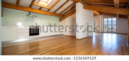 Kitchen in empty apartment with wooden beams. Nobody inside