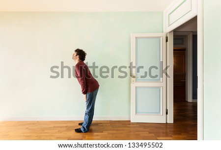 portrait of a weird guy in a room with the door open