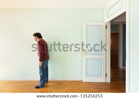 portrait of a weird guy in the room with the door open