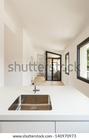 interior new house, modern white kitchen, view sink of steel