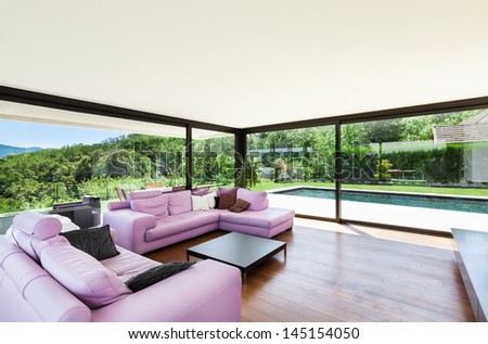 Modern villa, interior, wide living room with pink divan