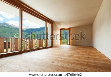new apartment in cement and wood, empty room with windows