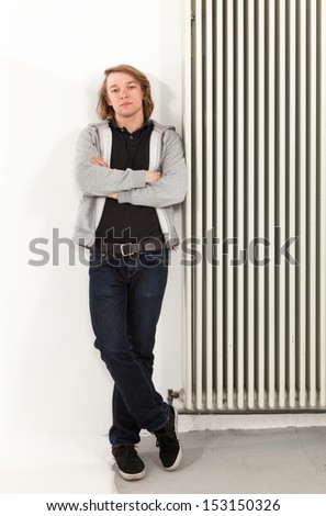 portrait of young man leaning on the radiator