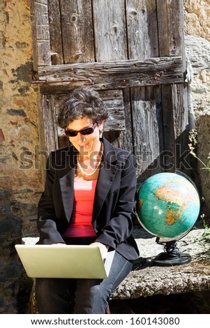 portrait of woman with her laptop, rural scene