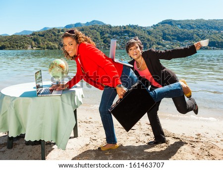 two funny; business women on the lake shore