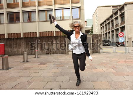 beautiful business woman run on pavement