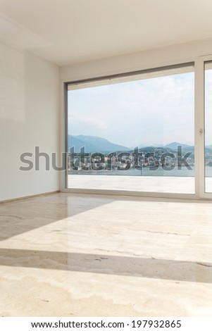 Interior, modern penthouse, empty living room with large windows