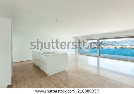 Interior, modern penthouse, empty living room with large windows