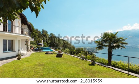 Nice terrace with swimming pool in a house, garden