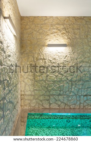 modern hotel spa interior, hot tub, stone wall