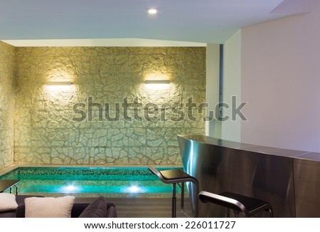 modern hotel spa interior, hot tub, stone wall