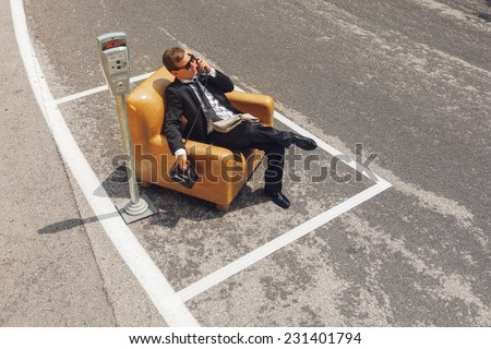 scene of businessmen who parks his armchair and call with old phone