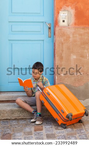 portrait of a boy sitting on the stairs of an old house