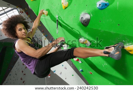 portrait of woman on artificial exercise climbing wall