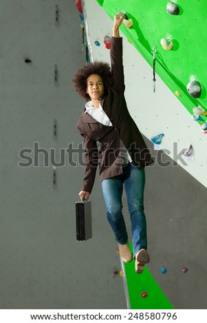 portrait of woman on artificial exercise climbing wall