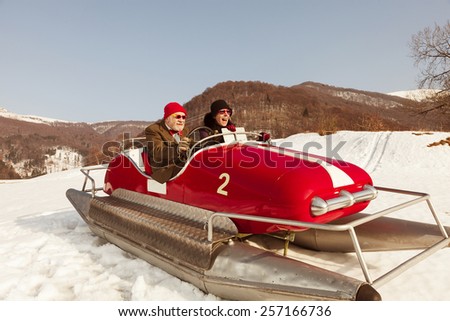 Elderly couple on a pedalo in the snow