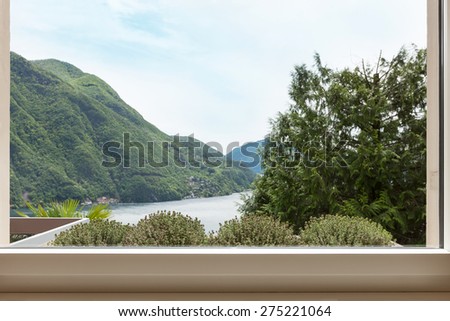 Interior, mountain landscape seen from a window of apartment