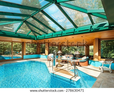 Interior of a residential house, large indoor pool, ceiling with skylights