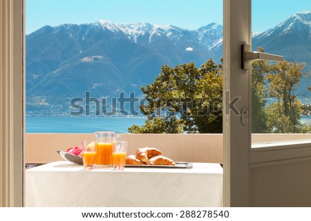 traditional breakfast on the balcony of a house, lake view