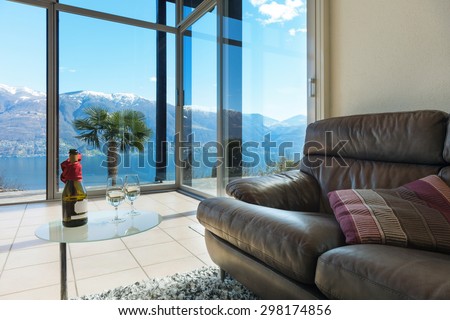 aperitif on the veranda, interior of a mountain home, lake view