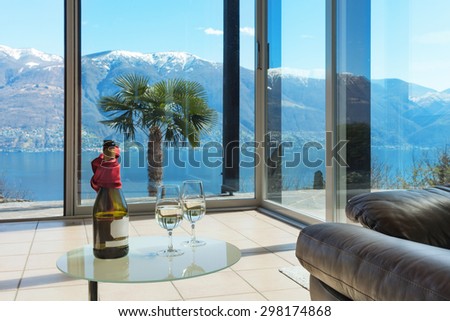 aperitif on the veranda, interior of a mountain home, lake view