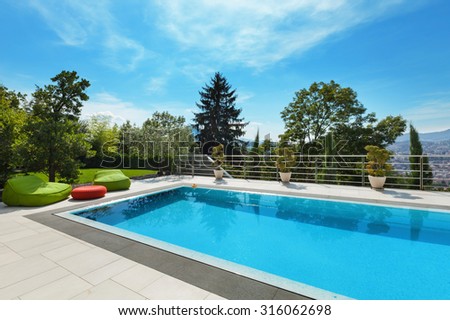 beautiful house, swimming pool nobody inside, summer day