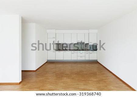 interior of an apartment, empty living room with kitchen, parquet floor