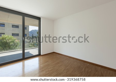interior of an apartment, empty living room with balcony, parquet floor