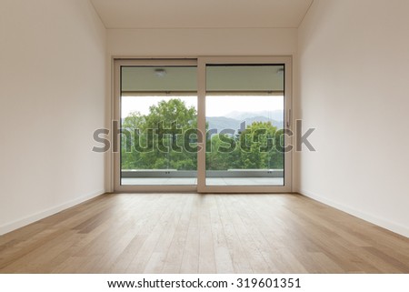 interior of new apartment, wide room with window, parquet floor