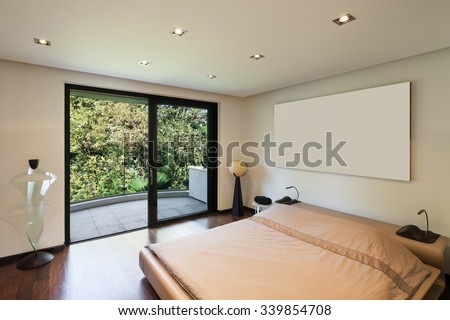 Interior of modern house, bedroom with balcony