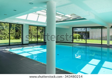 indoor swimming pool of a modern house with spa