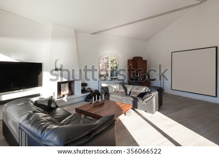 Interior of house, comfortable living room with leather divans