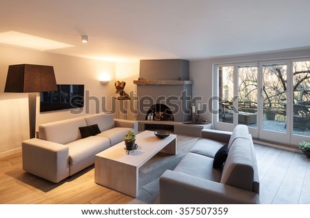 Interior of house, modern comfortable living room with fireplace
