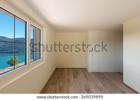 Interior of a new apartment, panoramic window on the lake