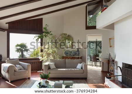 Interior; living room of a rustic house; divan and armchair