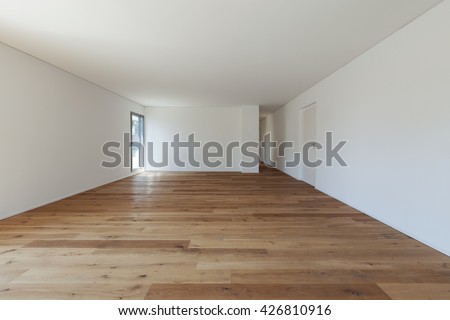 Interior of empty apartment, wide hall with parquet floor