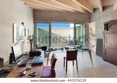 Interior of a modern loft, room with desks, concrete walls