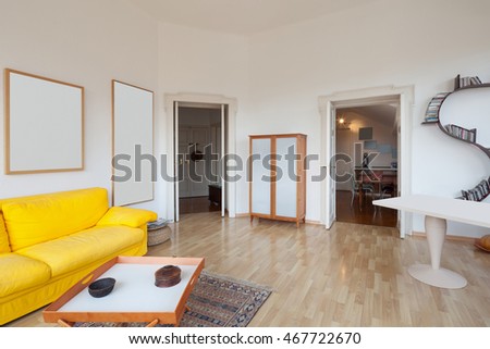 living room of old apartment, yellow divan and wooden floor